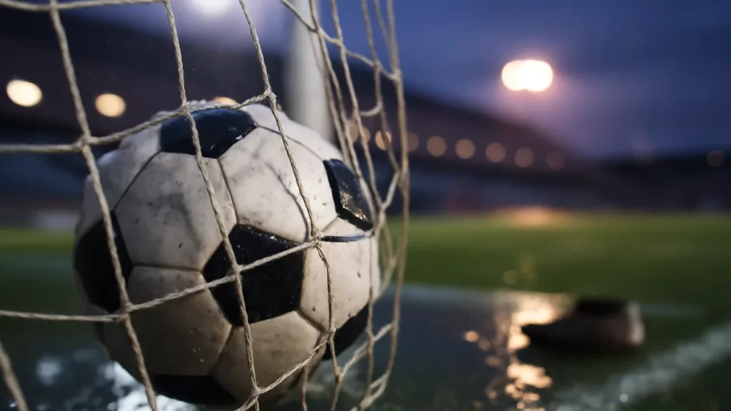 Barcelona rout Real Madrid 7-0 as Bonmatí returns and Pina nets four Football in wet goal net under floodlights, empty stands blurred behind