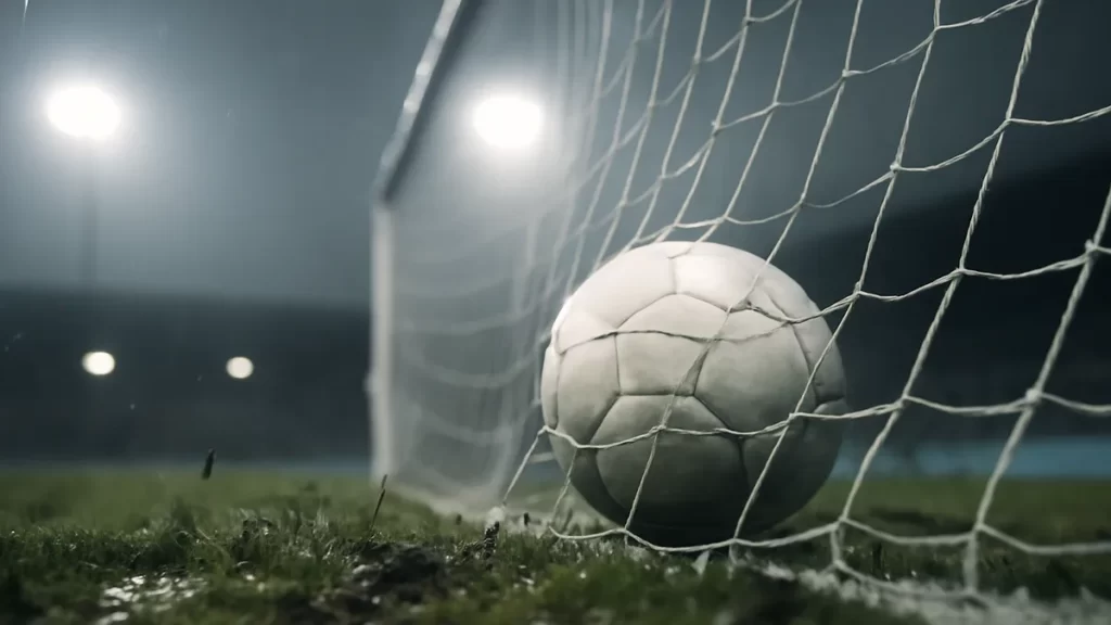 James and Russo lead England to 5-0 win and Ukraine playoff Football caught in the net on a wet pitch under floodlights.